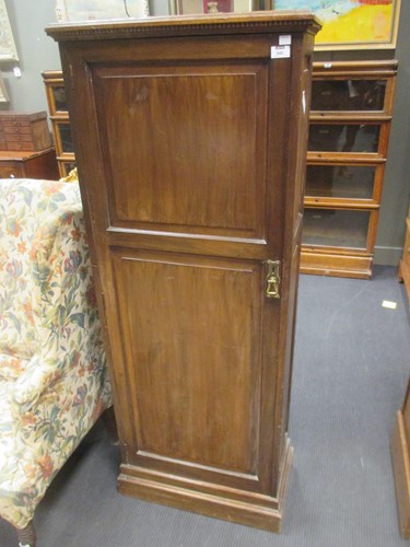 Lot 540 - An Edwardian walnut cupboard with shelves...