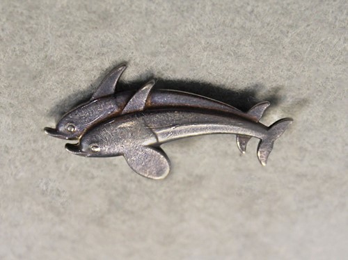 Lot 125 - Georg Jensen, a Danish metalwares brooch of leaping dolphins