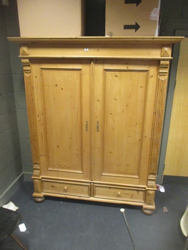 Lot 504 - A 20th century pine two door wardrobe with a...