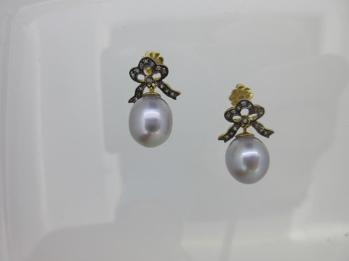 Lot 231 - A pair of cultured pearl and diamond bow earrings