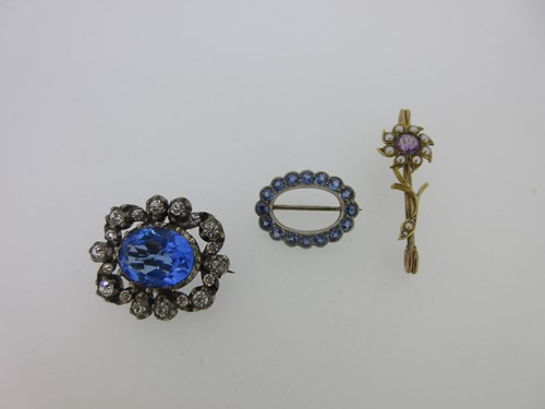 Lot 87 - A pale blue sapphire hoop brooch and two other gemset brooches