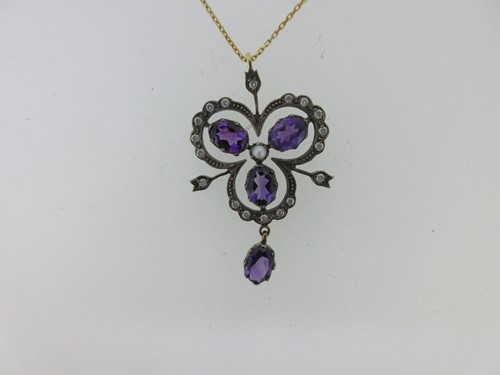 Lot 218 - An amethyst, diamond and seed pearl trefoil pendant with chain