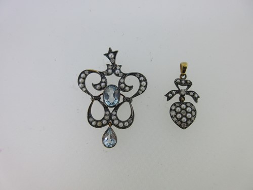 Lot 119 - A blue topaz, seed pearl and diamond pendant together with a seed pearl and diamond heart pendant