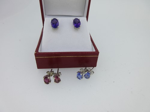 Lot 103 - Three pairs of single stone earstuds - tanzanite, amethyst and pink tourmaline