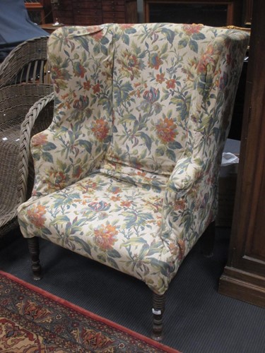 Lot 538 - A wingback armchair, upholstered floral...