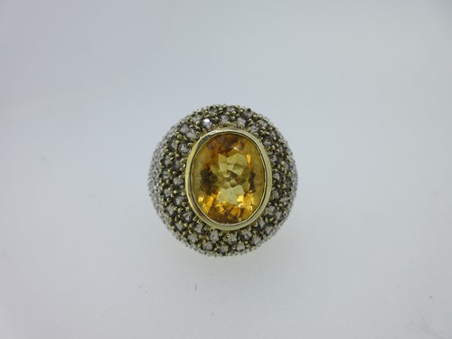 Lot 12 - A modern citrine, smoky quartz and diamond bombé ring