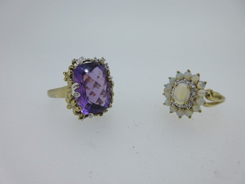 Lot 108 - An amethyst and diamond statement ring together with an opal and diamond cluster ring