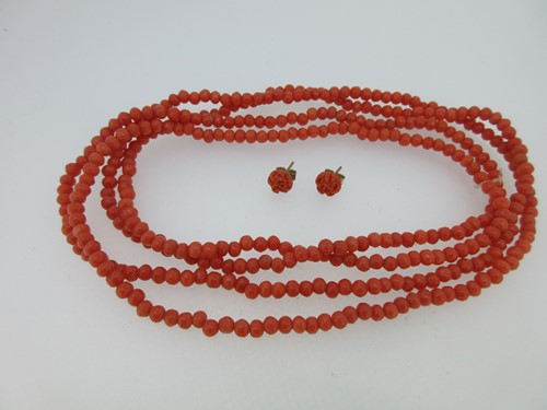 Lot 2 - A single row of coral beads and a pair of carved coral earstuds