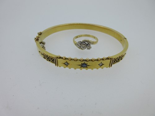 Lot 59 - A Victorian sapphire and diamond hinged bangle together with a diamond three stone ring