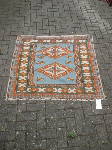Lot 555 - Three small Caucasian pattered rugs, 20th century
