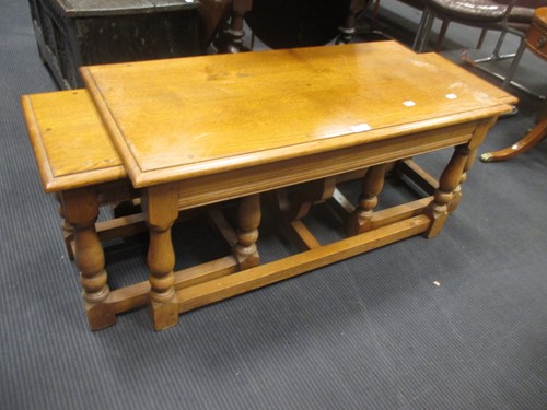 Lot 352 - A nest of oak tables, and another smaller nest...