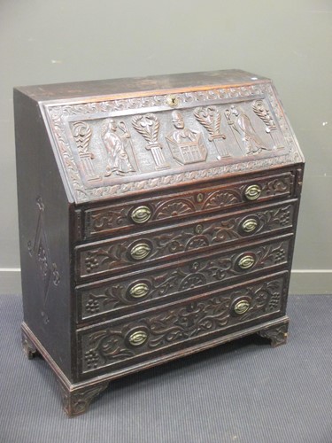Lot 334 - A Victorian carved oak bureau, with preaching...