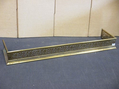 Lot 384 - A 19th century brass fender, pierced with...