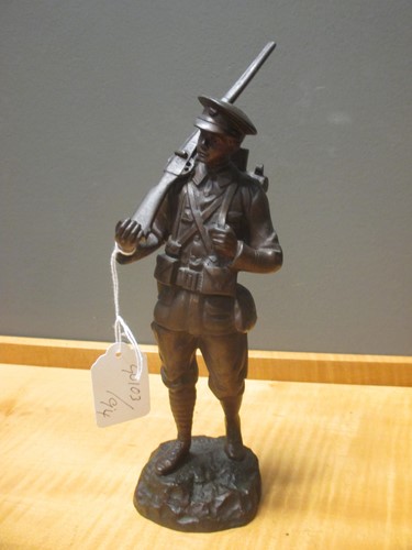 Lot 37 - A bronze model of a WWI soldier with rifle...