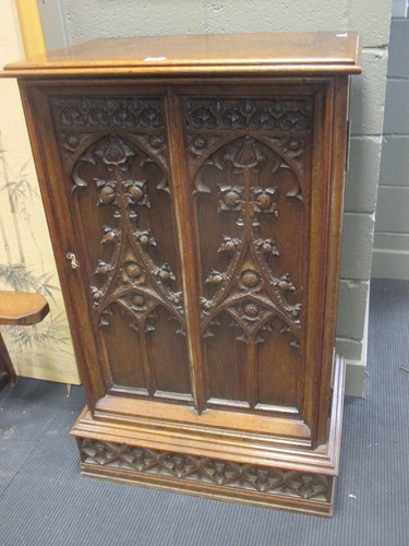 Lot 323 - A 19th century oak 'Gothic' carved cabinet,...