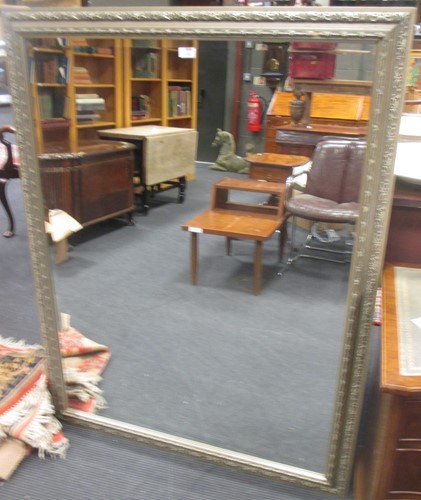 Lot 363 - A large silver painted rectangular wall mirror,...