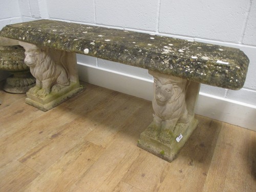 Lot 406 - A reconstituted stone garden bench with seated...