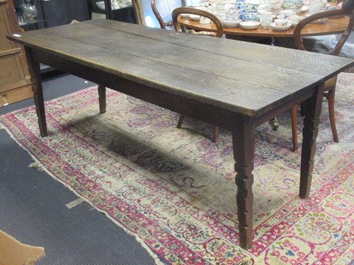 Lot 298 - A three plank oak dining table with four...