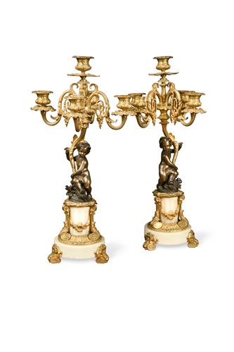 Lot 614 - A pair of Louis XV style bronze putto five light candelabra, circa 1900