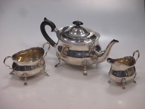 Lot 175 - A silver three piece teaset, William Hutton &...