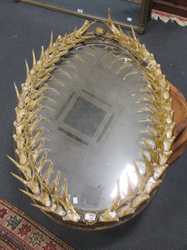 Lot 542 - An oval moulded resin 'antler' frame wall...