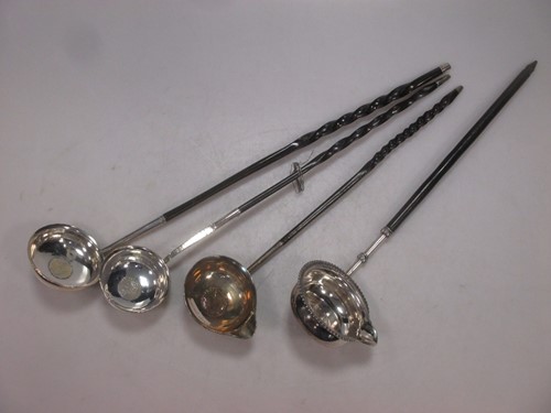 Lot 161 - Four punch ladles, the bowls with coin inserts....