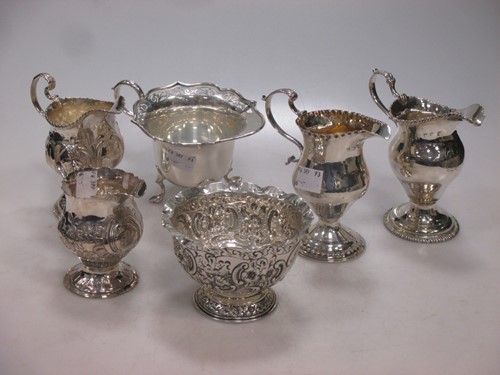 Lot 166 - A collection of five silver cream jugs...