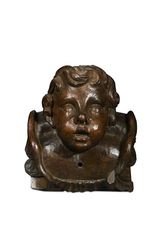 Lot 479 - An imposing carved cherub head wall mount, late 17th or early 18th century