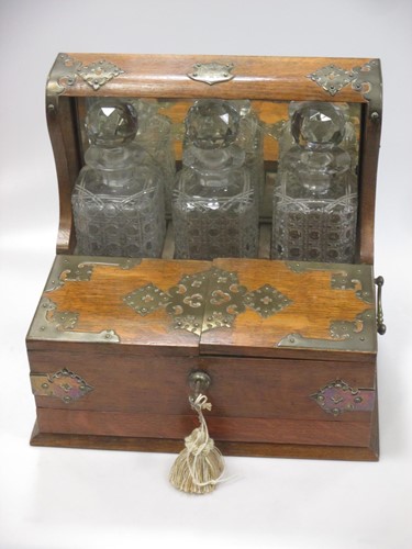 Lot 8 - A brass mounted three bottle oak tantalus