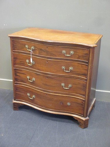Lot 374 - A Georgian mahogany serpentine fronted chest...