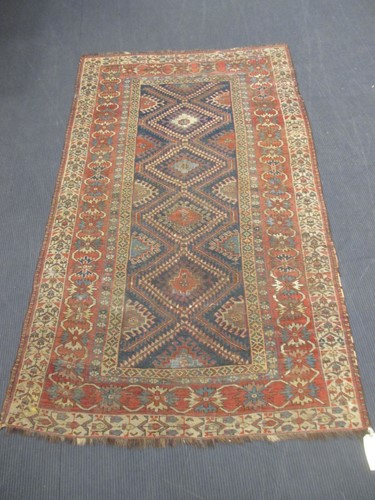 Lot 535 - A Caucasian carpet with red ground