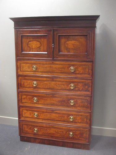 Lot 416 - An inlaid flame mahogany tallboy with two door...