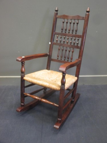 Lot 451 - Rush seat Lancashire spindle back oak rocking...