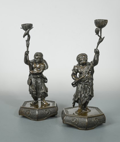 Lot 135 - A pair of Chinese bronze figural candle holders, Qing Dynasty late 19th century