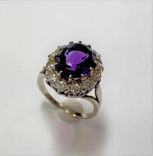 Lot 72 - An amethyst and diamond oval cluster ring