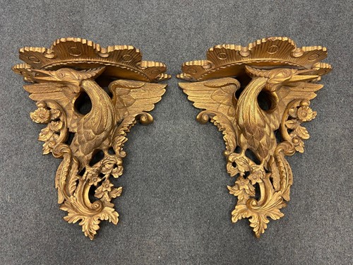 Lot 628 - A pair of carved and gilded wood eagle wall brackets