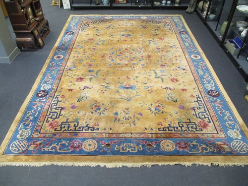 Lot 554 - A Chinese beige and blue ground carpet