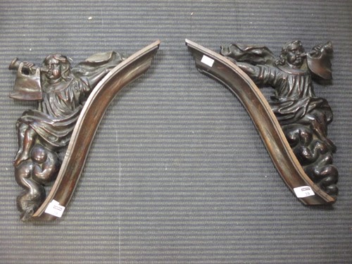 Lot 39 - A pair of oak brackets of trumpeters