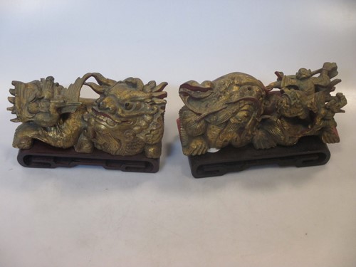 Lot 25 - A pair of Chinese carved giltwood dragons