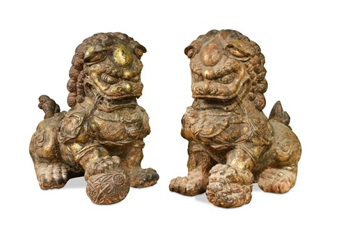 Lot 154 - A pair of Chinese cast iron and parcel gilt male and female foo dogs, 20th century