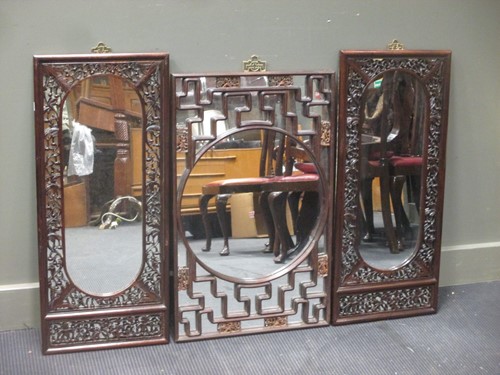 Lot 414 - Three rectangular Chinese carved wall mirrors,...