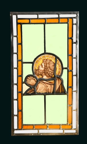Lot 395 - An 18th century stained glass section of a praying saint