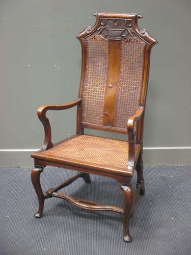 Lot 454 - An 18th century Spanish walnut caned elbow...