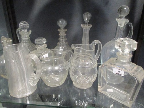 Lot 45 - A collection of ten cut glass jugs and decanters