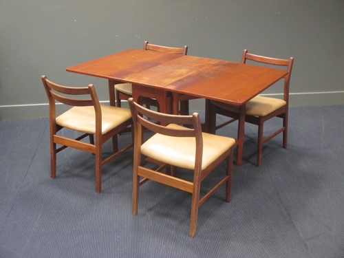Lot 493 - A 1970's teak drop leaf dining table with four...