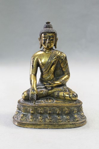 Lot 187 - A 19th century Tibetan gilt bronze model of Buddha