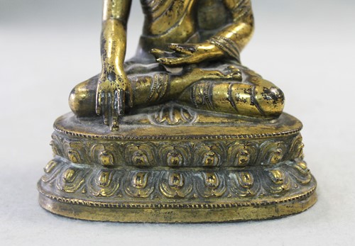 Lot 187 - A 19th century Tibetan gilt bronze model of Buddha