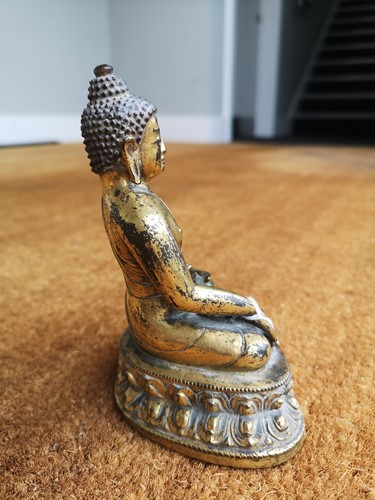 Lot 187 - A 19th century Tibetan gilt bronze model of Buddha