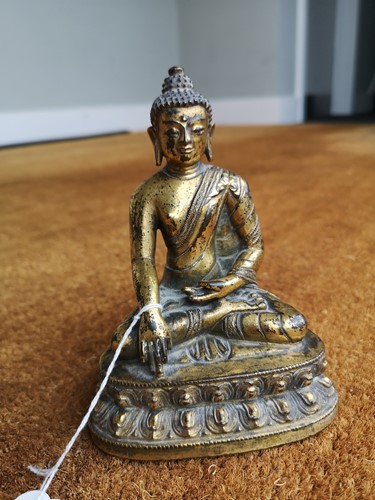 Lot 187 - A 19th century Tibetan gilt bronze model of Buddha