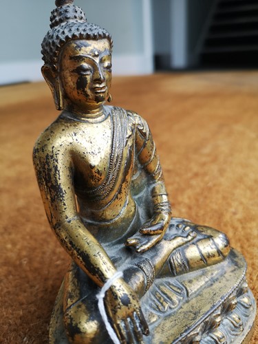 Lot 187 - A 19th century Tibetan gilt bronze model of Buddha
